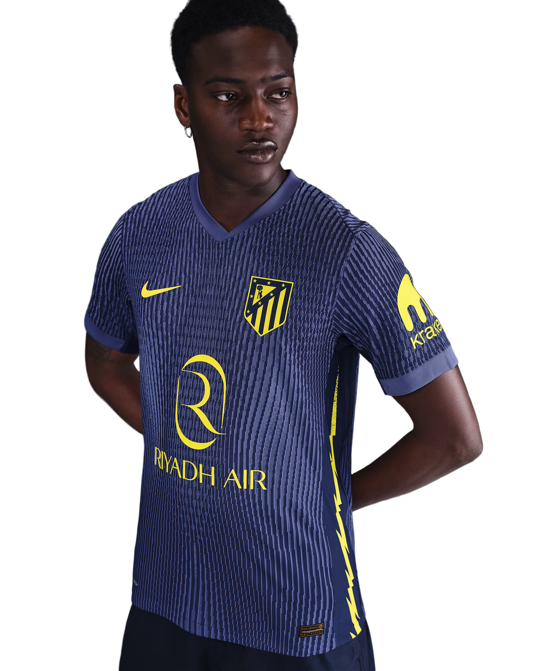 Person wearing a blue sports jersey with yellow accents and branding on a gray background