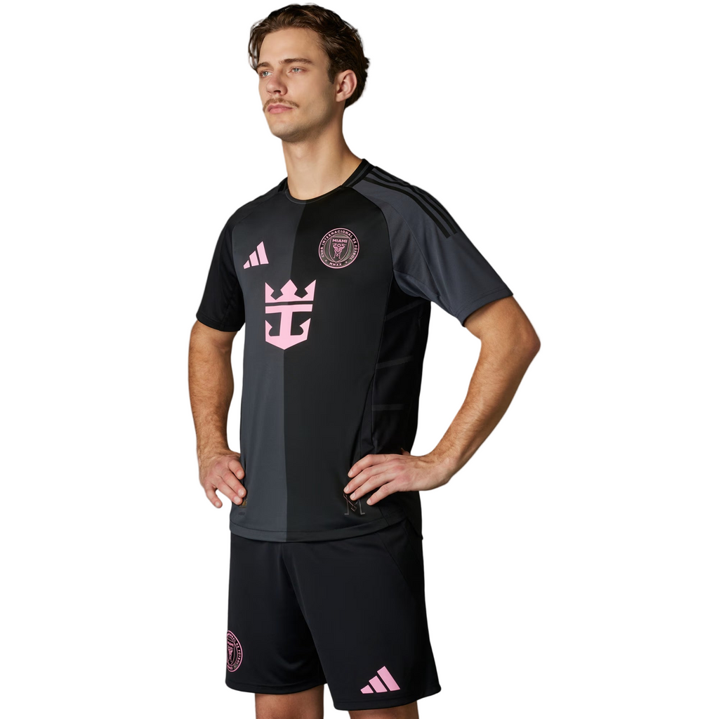 Man wearing a black sports outfit with pink accents on a gray background